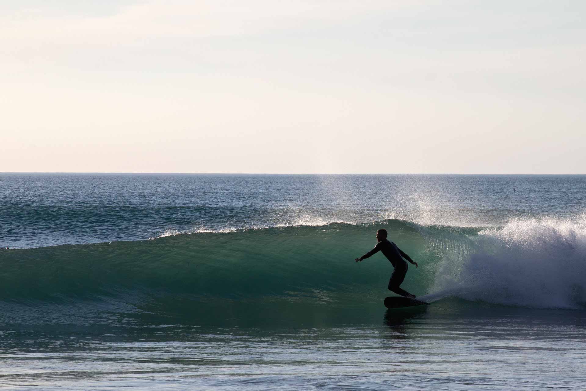 man surfing on the Cornish coast, near Kudhva, Tintagel