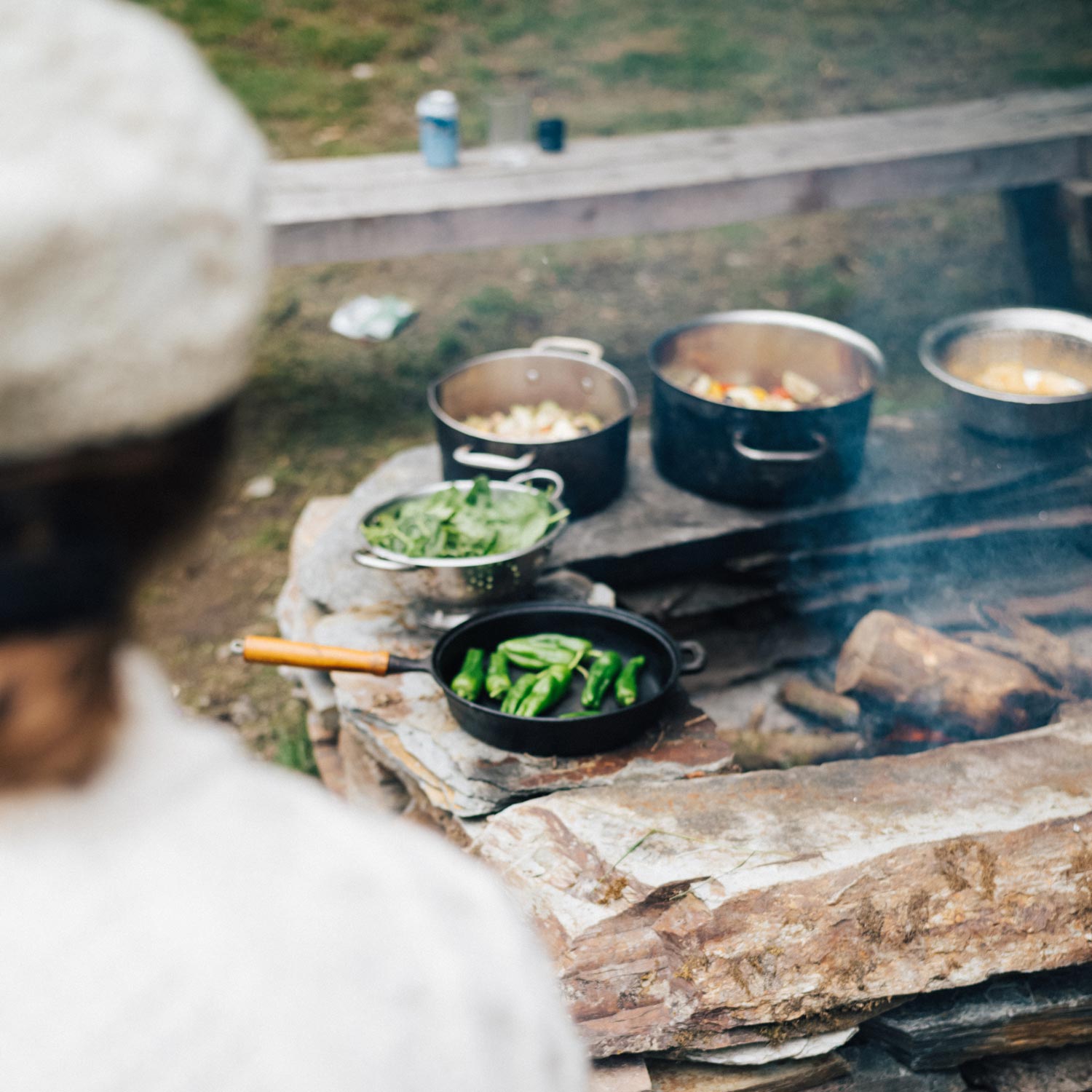 a selection of food cooked over a fire as part of Kudhva's off-grid lifestyle