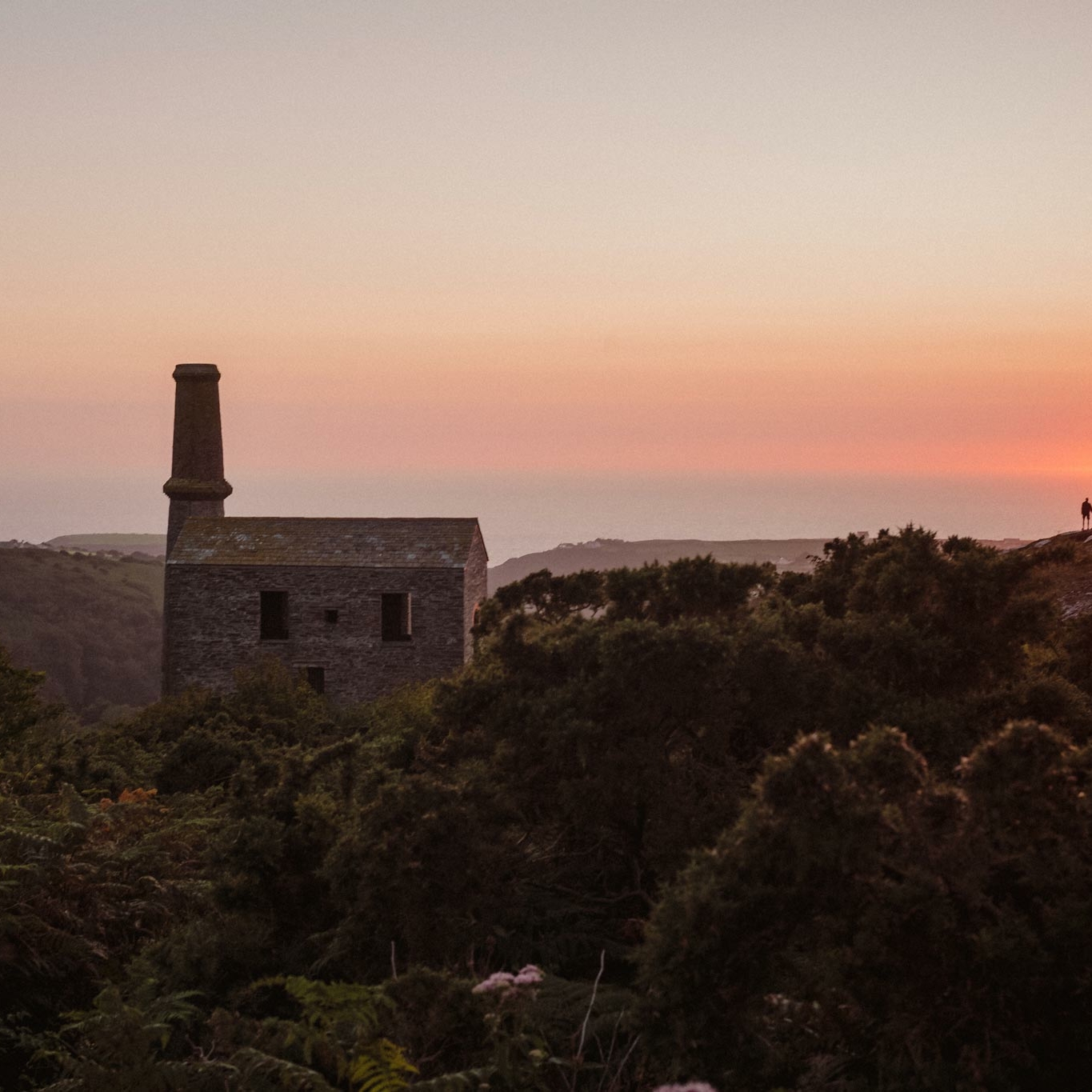 a view the Engine House at Kudhva, towards the Cornish sea and a beautiful pink sunset